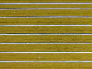 Small Polymer nozzle-plates, micropatterned conical spray orifices